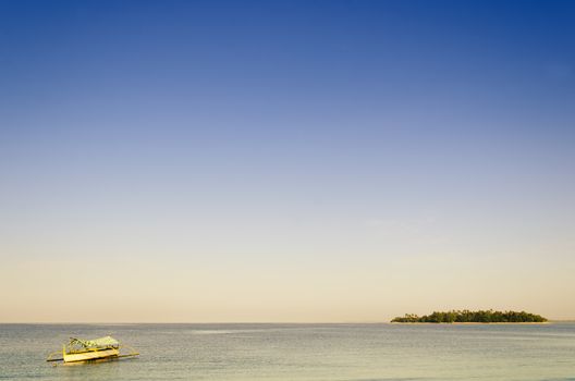 Outrigger off the coast of a tiny tropical island in the Philippines