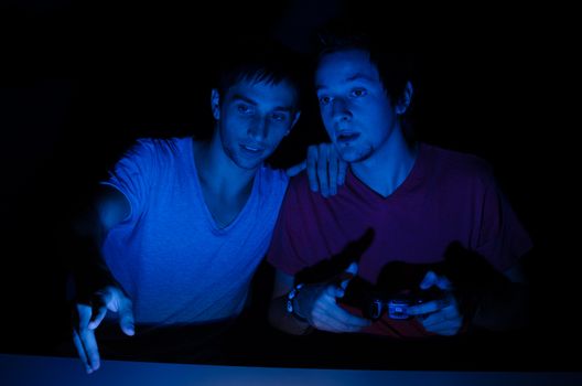 Two friends in front of a computer screen gaming