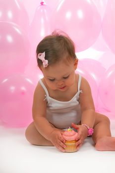 Baby eating her birhtday cupcake