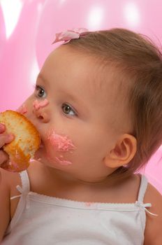 Birthday baby eating her birthday cupcake