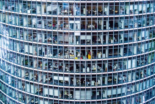 looking inside many offices of a skyscraper