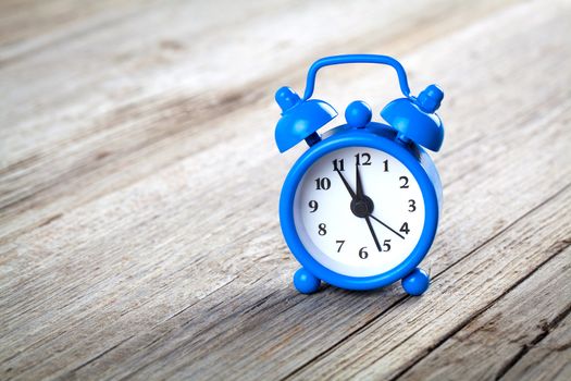 Vintage wooden background with retro alarm clock