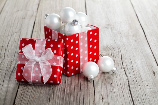 red gift box, polka dots with, on wood background