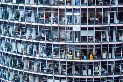 looking inside many offices of a skyscraper