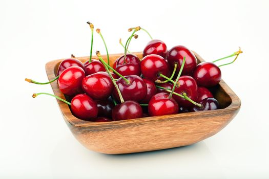 cherry berry in wooden bowl, isolated on white background