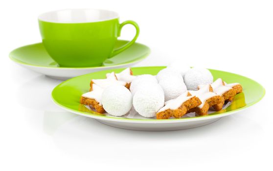 christmas cinnamon star cookies on green plate, on white