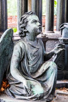 detail of a mourning sculpture on a cemetery