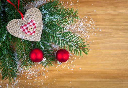 Christmas bauble with heart, on wooden background