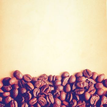 Coffee beans on old paper background with retro filter effect