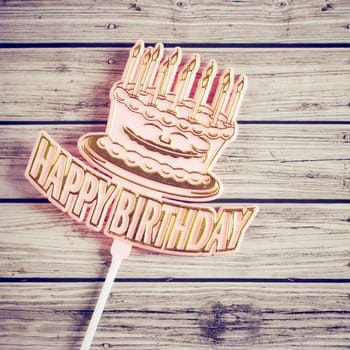 Happy birthday on wooden background with retro filter effect