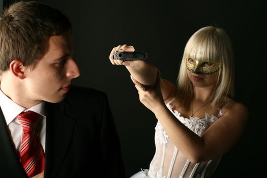 bride in white dress with pistol wants to kill her boy in black