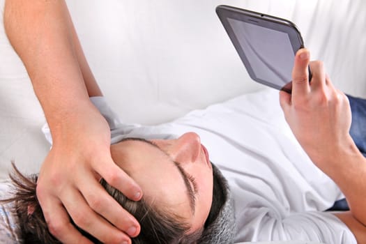 Young Man with Tablet Computer on the bed