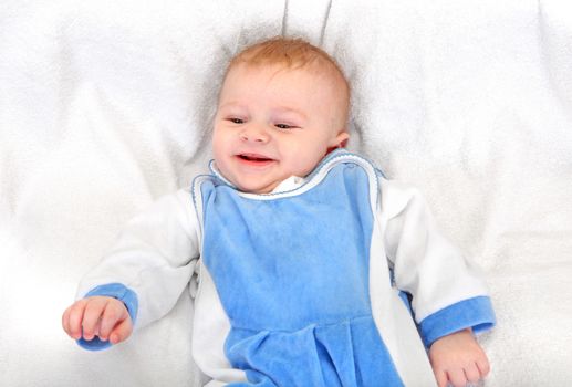 Happy Baby Boy Portrait on the White blanket