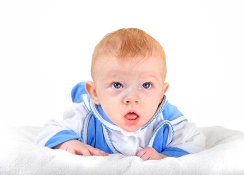 Surprised Baby Boy lying on the White blanket