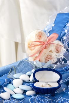 flowers and wedding rings on white background