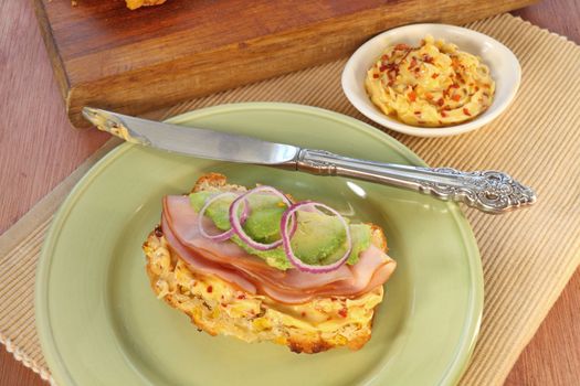 Corn bread sandwich with ham, chili butter, avocado and red onion.