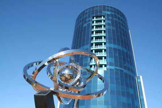 Ultra modern corporate high rise with chrome decorative piece.