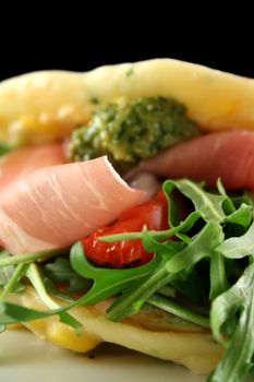 Corn fritters with prosciutto, sundried tomatoes and pesto.