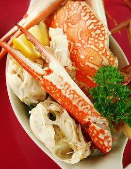 Cracked sand crab with lemon ready to serve.