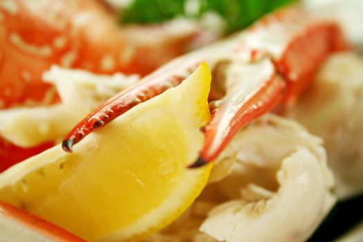 Cracked sand crab claw with lemon ready to serve.