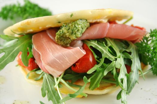 Corn fritters with prosciutto, sundried tomatoes and pesto.