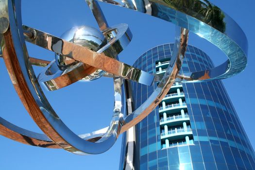 Ultra modern corporate high rise with chrome decorative piece.