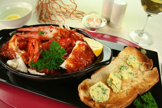 Delicious fresh cracked sand crab in a spicy tomato sauce with toast and herb butter.