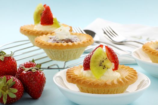 Delicious and decadent cream and chocolate tarts with fresh strawberries.