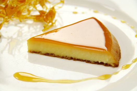 Slice of creme caramel with golden almond praline.