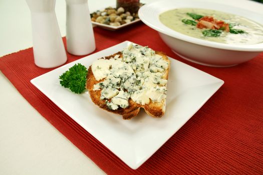 Creamy spinach soup with crispy bacon and blue cheese toast.