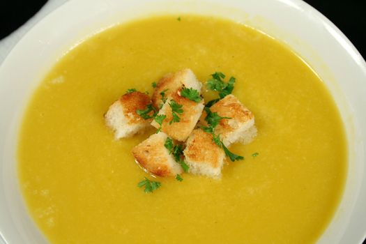 Delicious croutons floating in freshly made pumpkin soup.