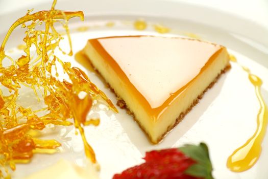 Slice of creme caramel with golden almond praline.