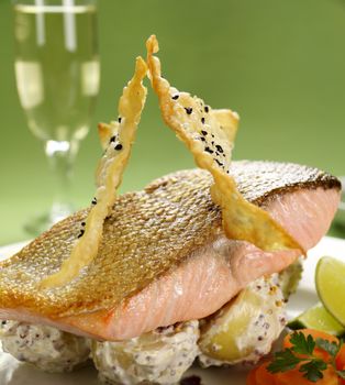 Delicious crispy skin salmon with fried wontons on a bed of mustard potatoes.