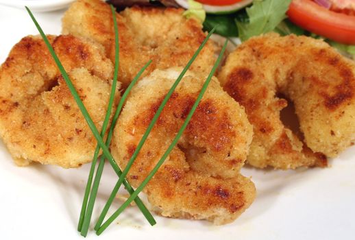 Delightful lightly fried crumbed shrimps ready to serve.