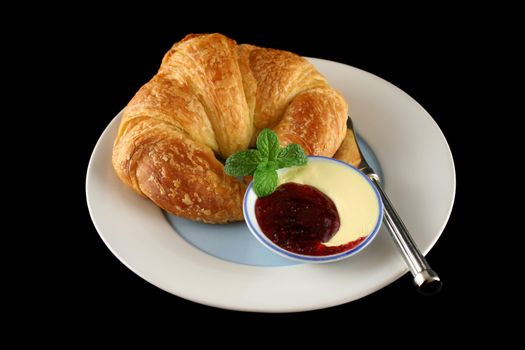 Delicious crisp and fresh croissant with jam and butter.