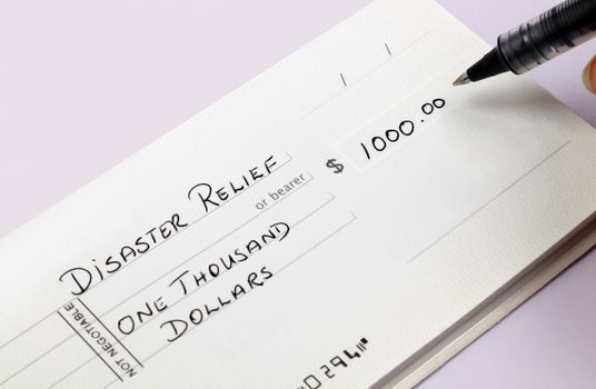 A disaster relief check being written for one thousand dollars.