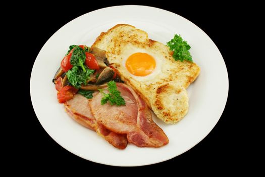 Egg embedded in toast with bacon, mushrooms, spinach and tomatoes.