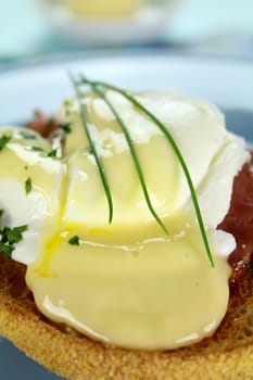Delicious breakfast of eggs benedict with beautiful rich hollandaise sauce.