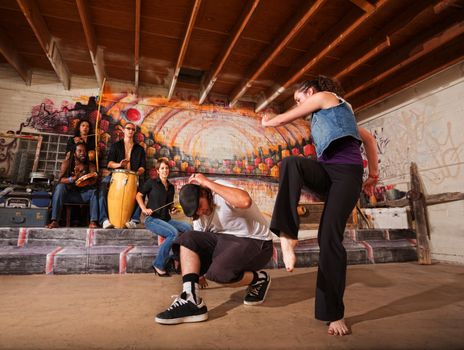 Musicians playing during a capoeira performance indoors