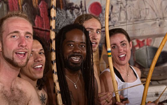 Group of capoeira martial artists singing together