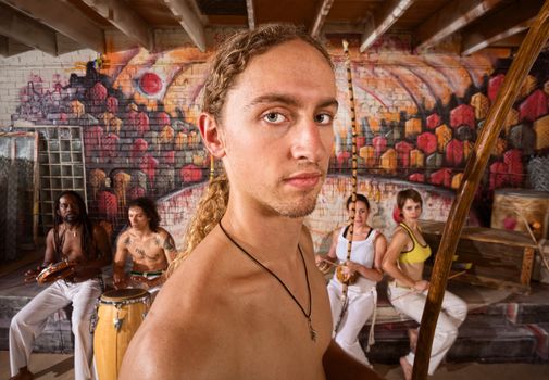 Close up of capoeira musician and group with instruments
