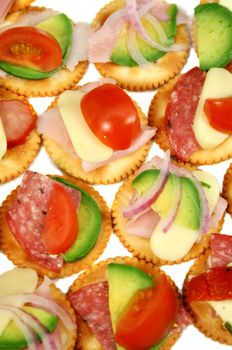Finger food of cracker biscuits with various toppings.