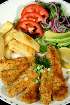 Crumbed fish and chips with salad.