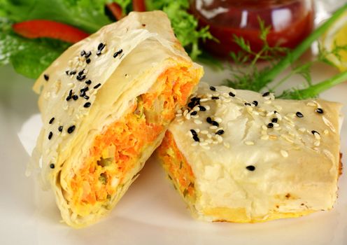 Fresh baked vegetarian carrot and feta filo rolls ready to serve.