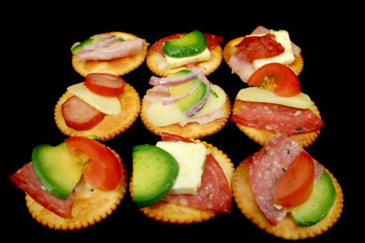 Delicious assortment of cracker snacks with various toppings.