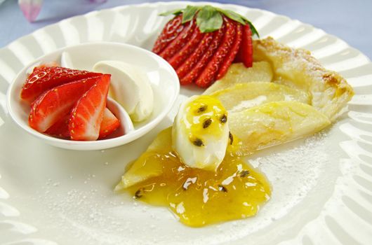 Delicious flat apple pie with strawberries and passionfruit.