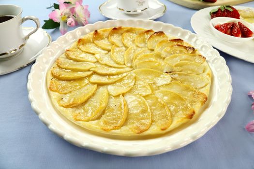 Delicious flat apple pie with strawberries and passionfruit.