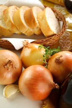 Fresh onions, garlic and thyme with sliced bread.