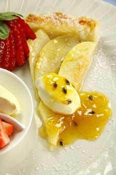 Delicious flat apple pie with strawberries and passionfruit.