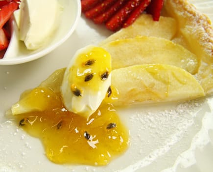 Delicious flat apple pie with strawberries and passionfruit.